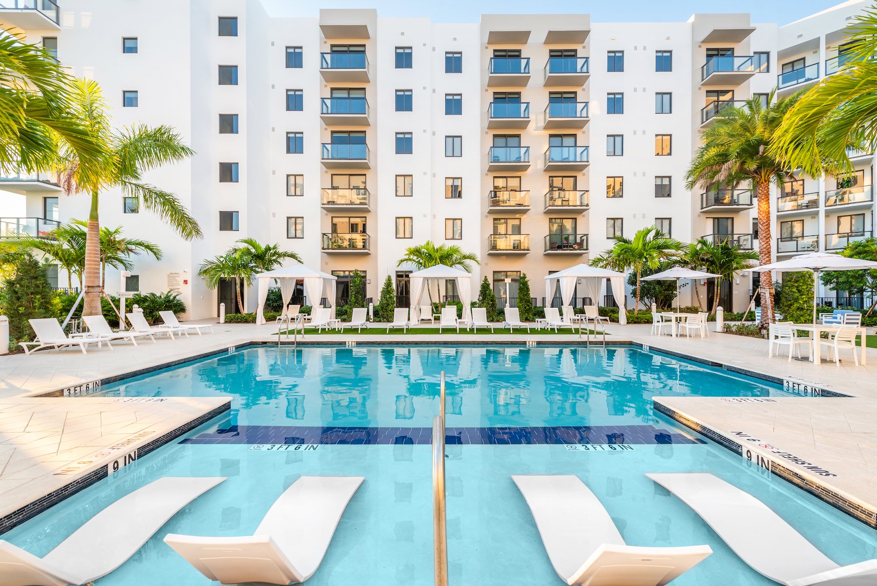 Relax and unwind poolside pool with lounge chairs