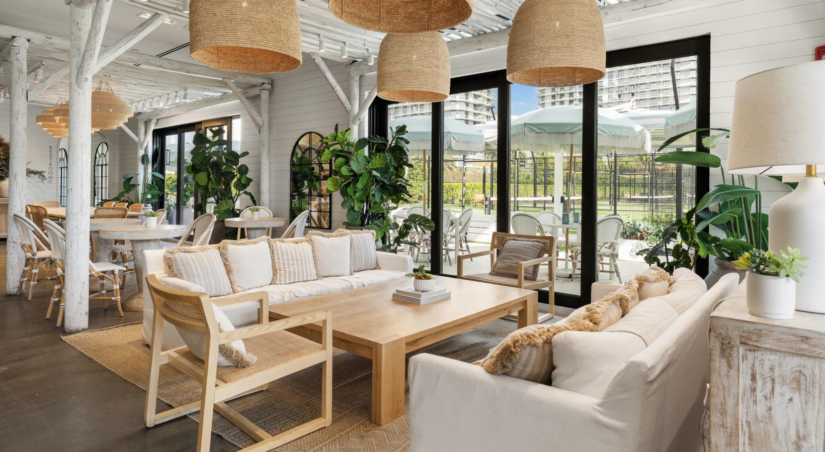 Pura Vida's fresh flavors, wellness-focused dining, and everyday convenience are just outside your door. a clubroom with couches, tables and chairs