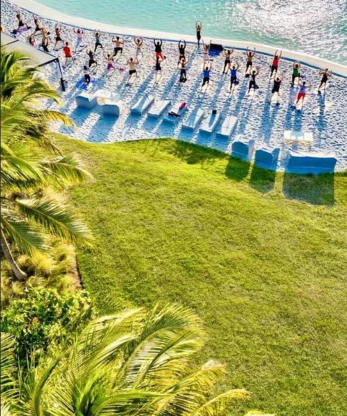 YOGA CLASSES people doing yoga on a beach