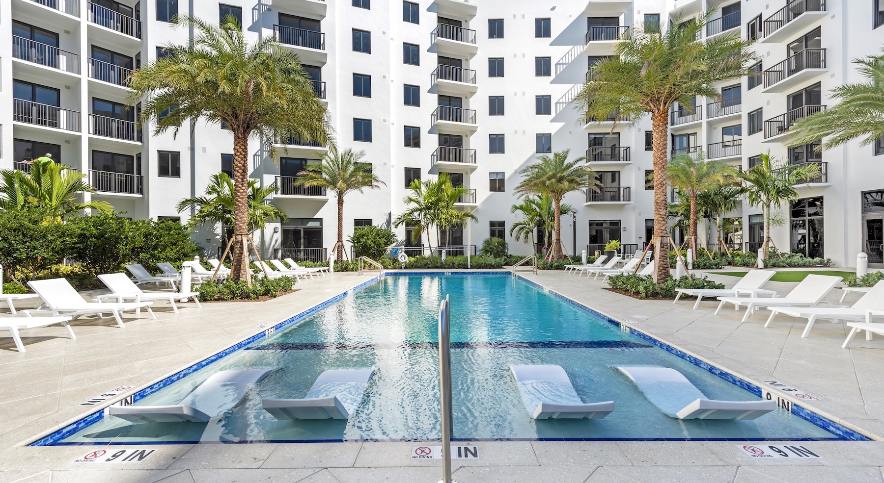 Resort-style swimming pool with lounge seating