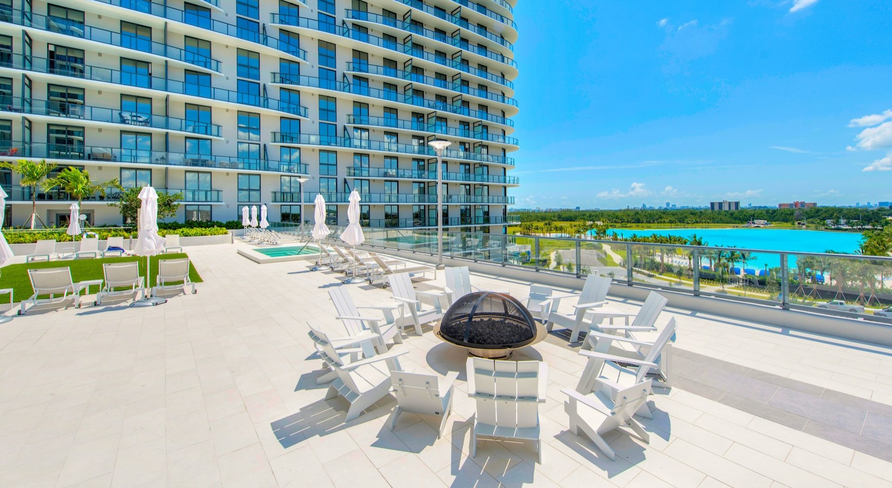 a patio with chairs and a fire pit