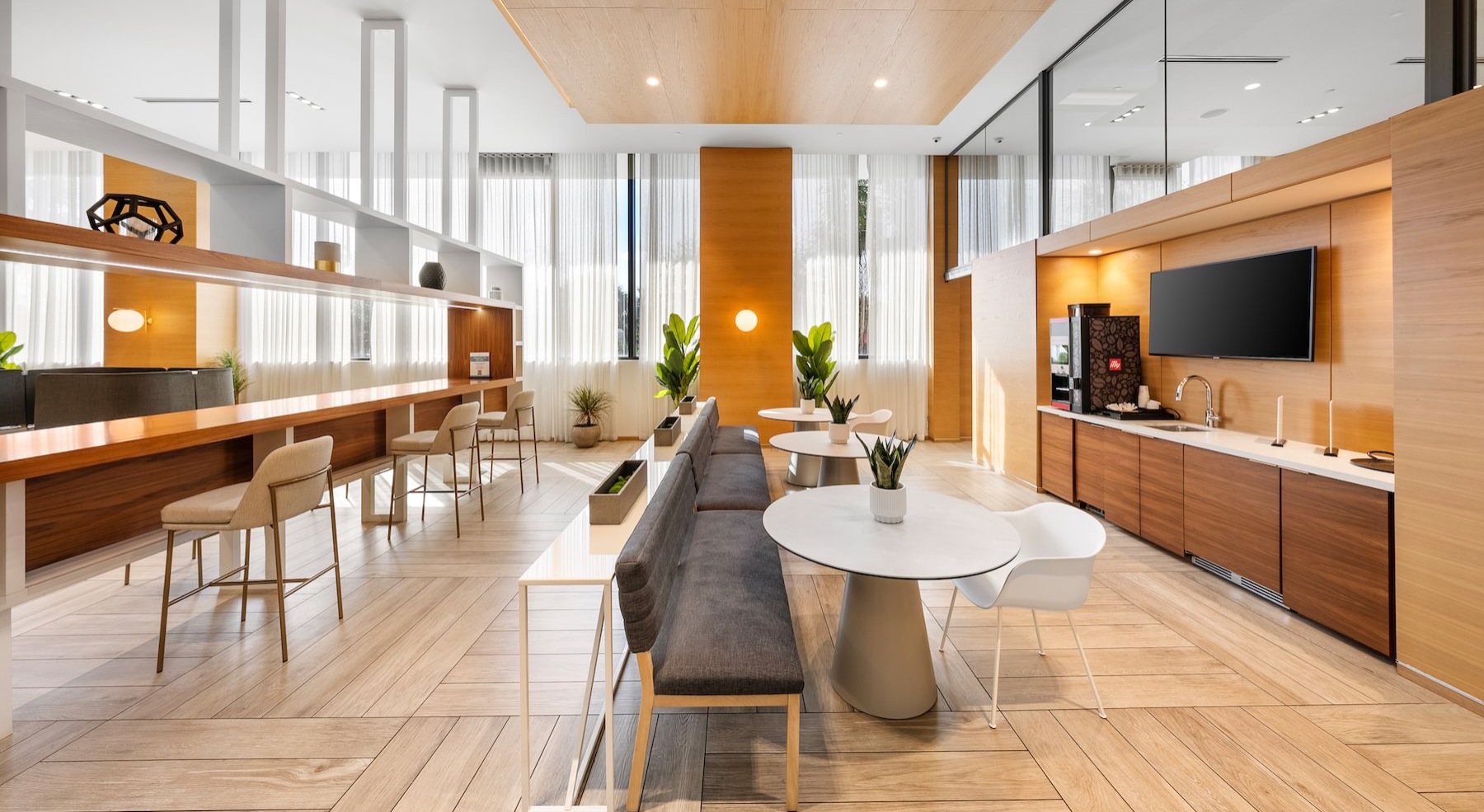 a clubroom kitchen with tables and chairs