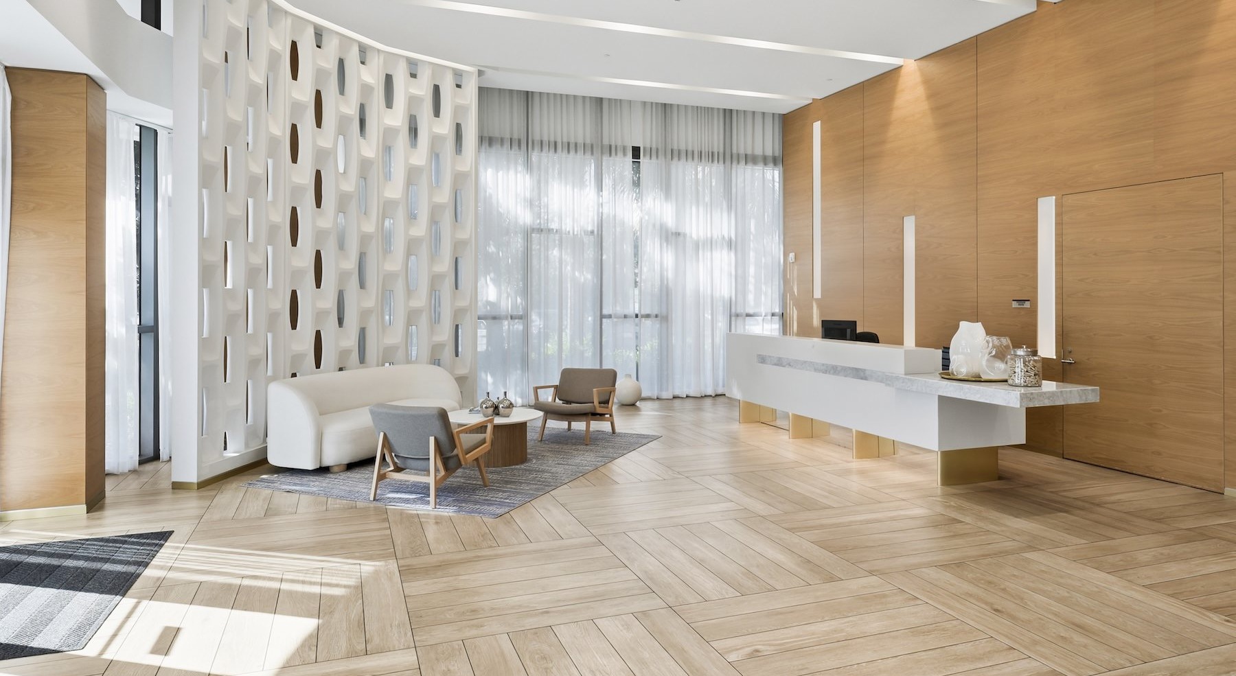 a leasing office with a desk and a couch