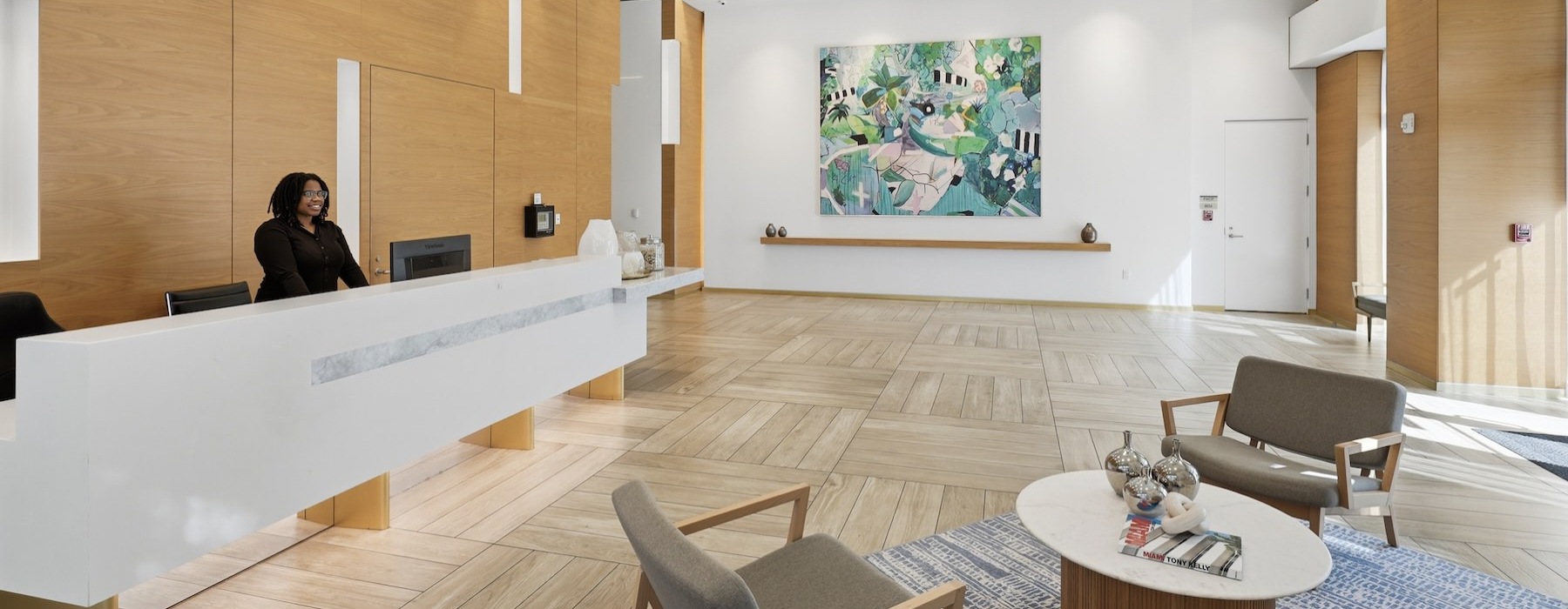 a person standing behind a leasing office front desk