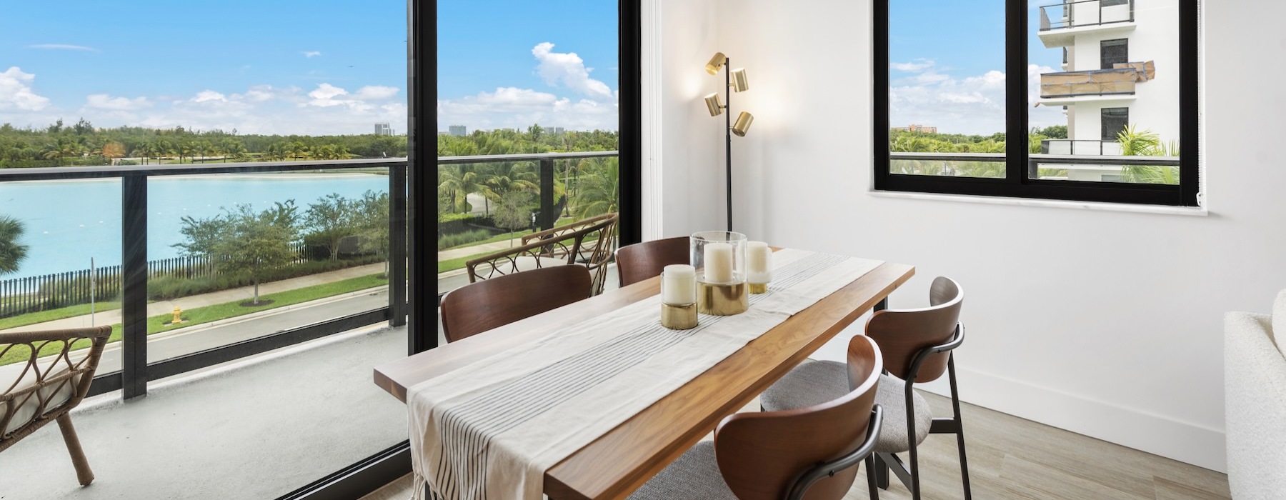 a dining table and chairs in a room with windows