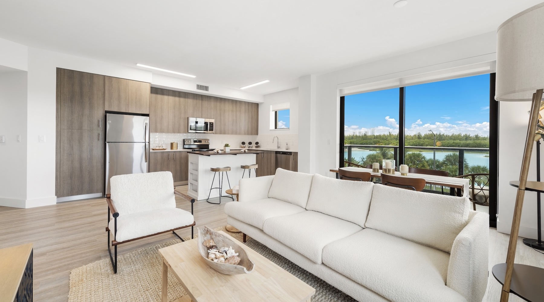 living room with furniture and a view of kitchen and windows