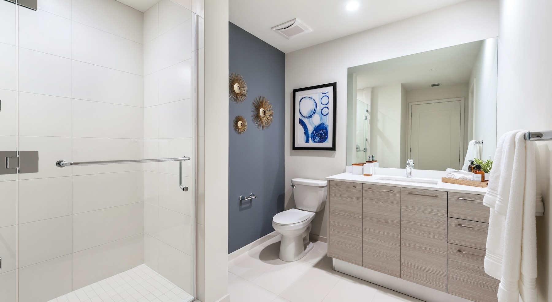a bathroom with a shower, toilet and sink