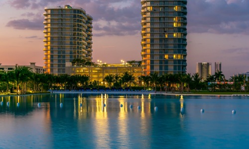 a large pool with buildings in the background