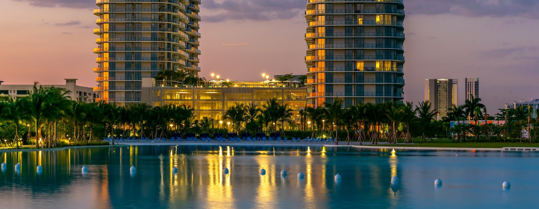 a large pool with buildings in the background