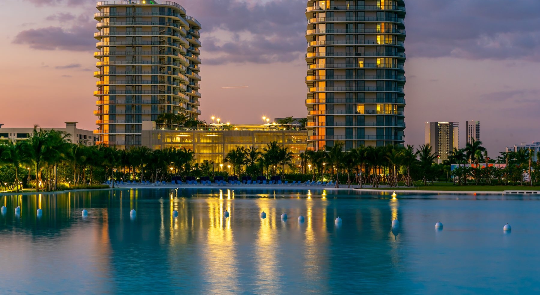 a large pool with buildings in the background