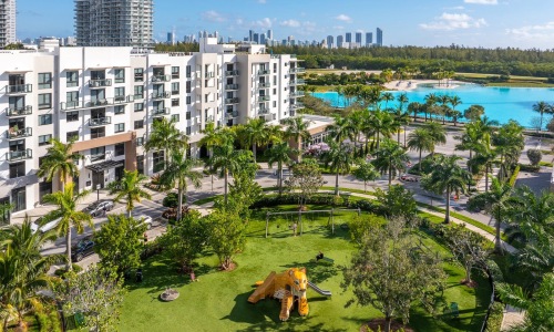 a courtyard with grass trees and a playground made out of a fake tiger