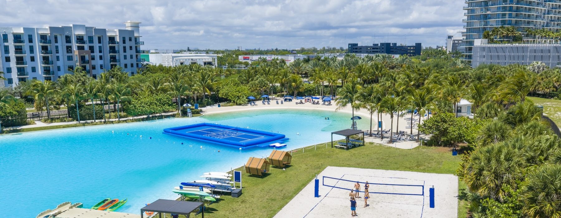 an aerial view of a large pool with trees