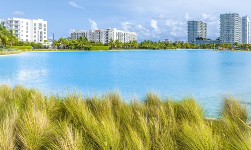 a body of water with buildings in the background