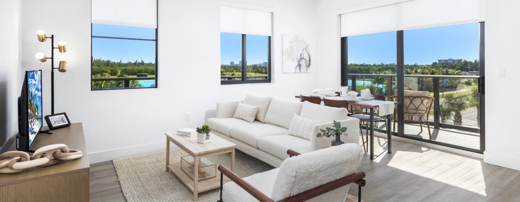 a living room with a couch, chairs and a tv